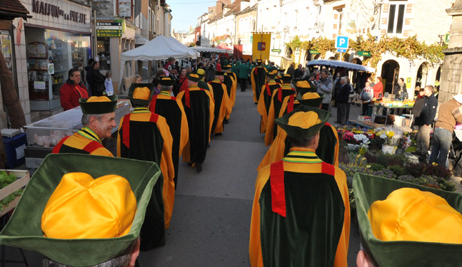 A parade of Les Piliers Chablisiens in the streets of Chablis
                